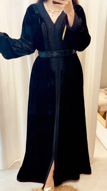 une femme porte le caftan baccara premium noir en velours avec ceinture