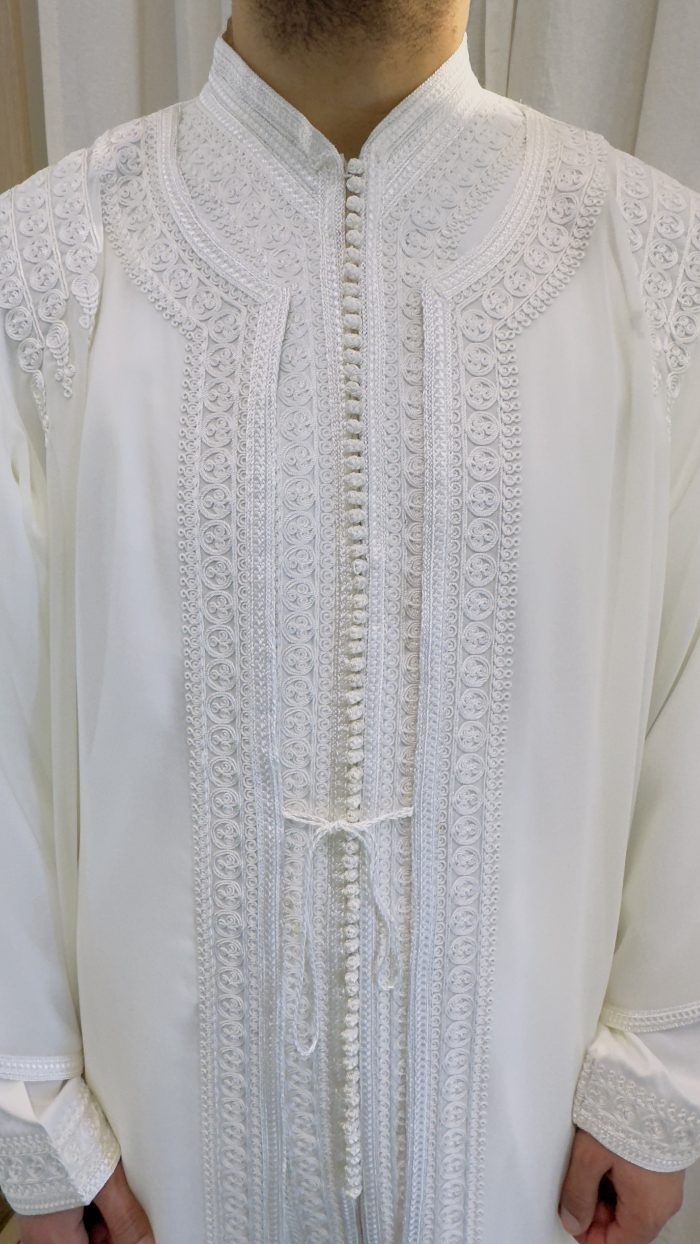 homme qui porte un jabador, un ensemble en trois pièces traditionnel marocain en couleur blanche